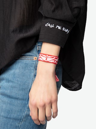 Woven Zadig Bracelet - Red woven bracelet adorned with embroidered wings and cords.