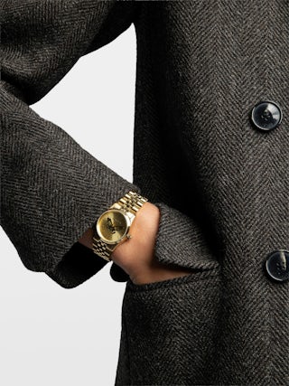 Zadig Small Watch - Stainless steel watch with silver dial featuring orange rhinestone wings and steel bracelet.