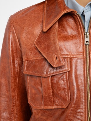 Lienna Leather Jacket - Glossy leather jacket with multiple pockets featuring zip closure and embossed wings on the back.