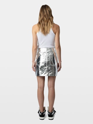 John Leather Skirt - Short leather skirt with metallic effect featuring zip closure, pockets and cut-out details.