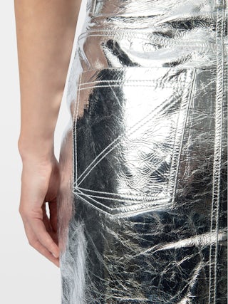 John Leather Skirt - Short leather skirt with metallic effect featuring zip closure, pockets and cut-out details.