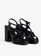 Forget Me Knot Sandals - Women’s black leather high-heeled sandals with strap and bow.
