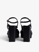 Forget Me Knot Sandals - Women’s black leather high-heeled sandals with strap and bow.
