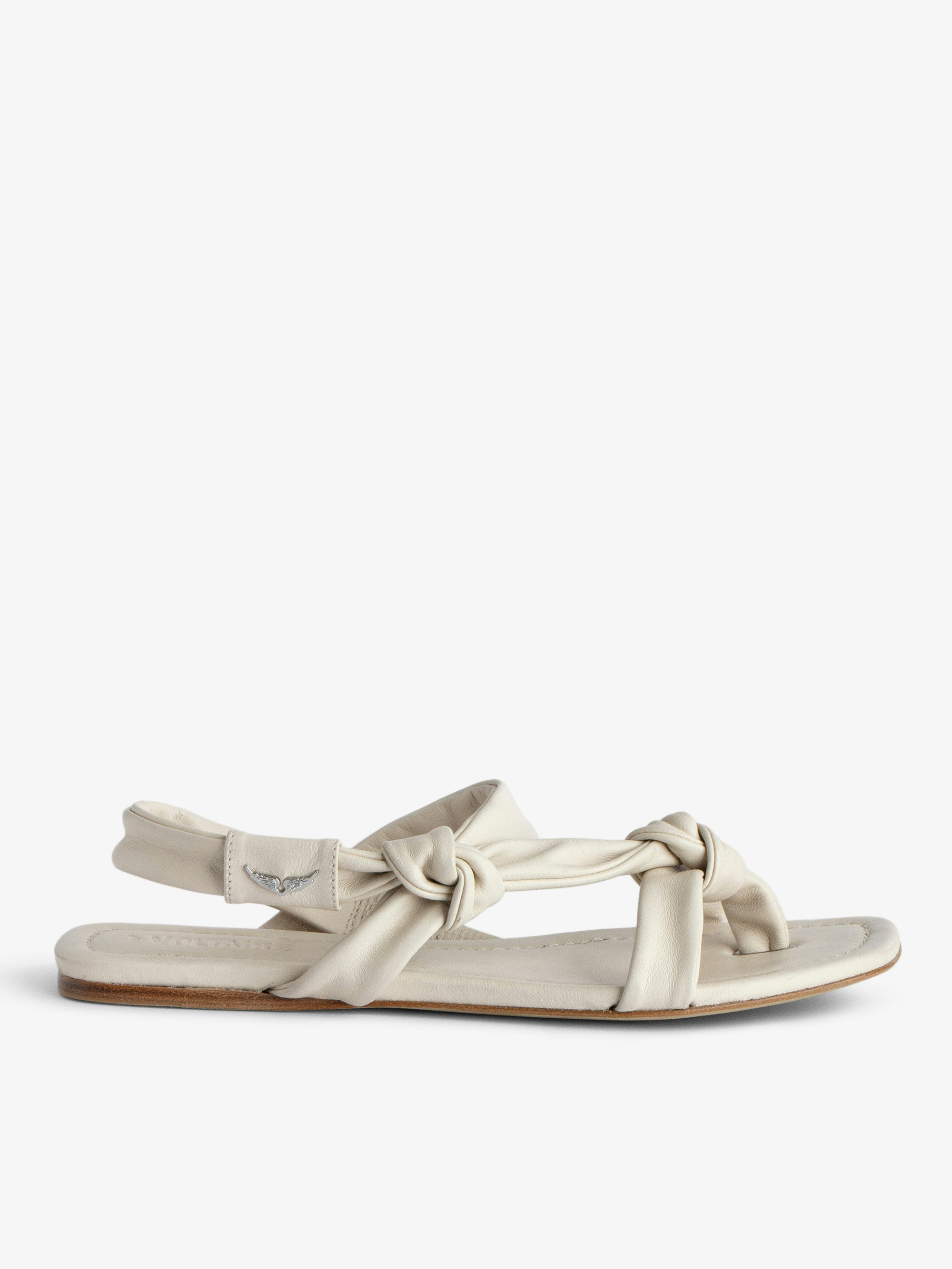 Forget Me Knot Sandals - Women's white  flat leather sandals with wing motifs.