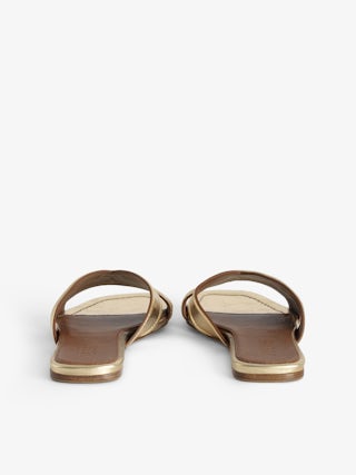 Azora Mules - A harmonious blend of edgy design and luxurious craftsmanship. These mules feature a metallic crinkled leather exterior, exuding a bold yet sophisticated allure. The embossed signature wings add a distinctive touch, embodying the brand's rebellious spirit. Designed with a square toe and crossover strap at the toe, they offer both style and comfort.