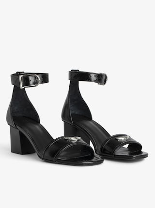 Caprese Sandals - Heeled sandals with leather strap adorned with a wing charm and a signature buckle.