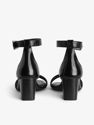 Caprese Sandals - Heeled sandals with leather strap adorned with a wing charm and a signature buckle.