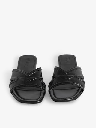 Azora Vintage Patent Mules - A perfect blend of vintage charm and modern sophistication. These leather mule sandals are crafted from premium vintage-effect leather, offering a timeless appeal. The design is accentuated by embossed signature wings, adding a distinctive touch that embodies the brand's edgy aesthetic. Elevate your footwear collection with these leather mule sandals that seamlessly combine comfort and style.