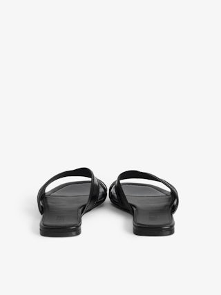 Azora Vintage Patent Mules - A perfect blend of vintage charm and modern sophistication. These leather mule sandals are crafted from premium vintage-effect leather, offering a timeless appeal. The design is accentuated by embossed signature wings, adding a distinctive touch that embodies the brand's edgy aesthetic. Elevate your footwear collection with these leather mule sandals that seamlessly combine comfort and style.