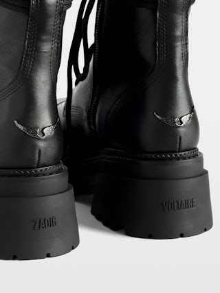 Ride High-Top Boots - High-top ankle boots in smooth semi-glossy black leather adorned with a wing charm and laces.