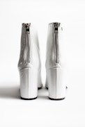 Glimmer Vernis Ankle Boots - Women’s heeled ankle boots in white patent leather.