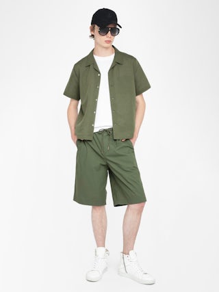 Pally Bermuda Shorts - Knee-length wide bermuda shorts with elasticated waistband and drawstring, central button fastening and zip closure, accompanied by a western-inspired embroidery.