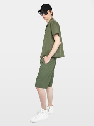 Pally Bermuda Shorts - Knee-length wide Bermuda shorts with elasticated waistband and drawstring, central button fastening and zip closure, accompanied by a western-inspired embroidery.