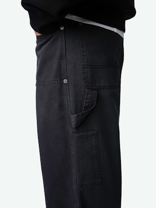 Perry Trousers - Worker-style trousers with front patch and rivet details.