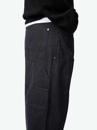 Perry Trousers - Worker-style trousers with front patch and rivet details.