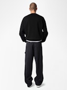 Perry Pants - Black worker-style pants with front patch and rivet details.