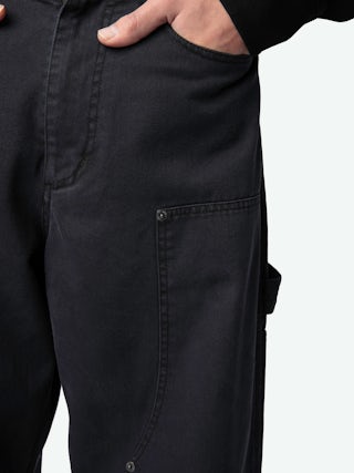 Perry Trousers - Worker-style trousers with front patch and rivet details.