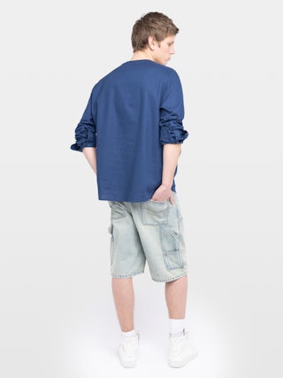 Camisa Sora - Camisa ligera con cuello Henley, cierre abotonado, mangas sutilmente abullonadas, bordado de alas distintivo.