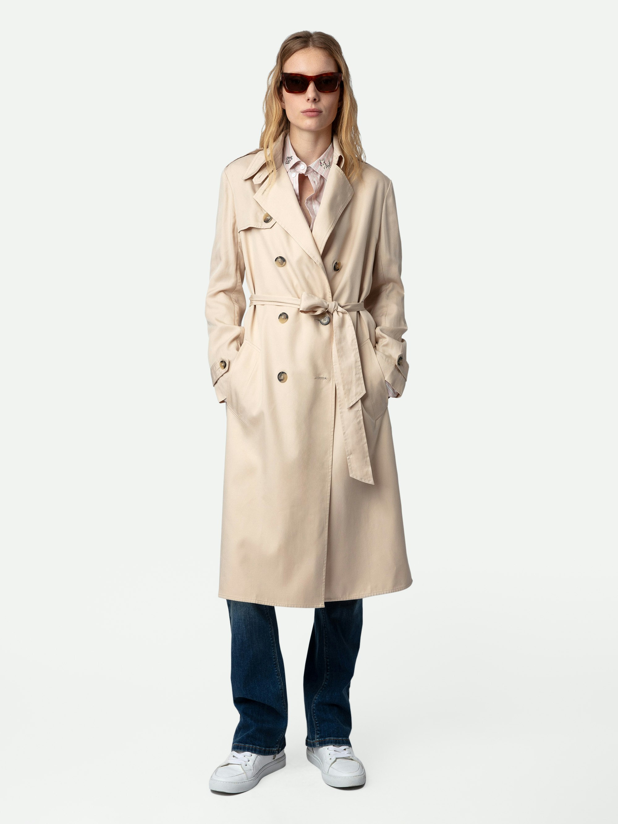 La Parisienne Trench Coat - Long beige trench coat with button closure and tie at the waist.