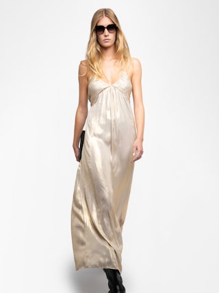 Rayonne Satin Dress - This long, pleated dress is crafted from luxurious satin, featuring a lingerie-inspired design with a sultry slit and adjustable cross-over straps for a personalized fit. Available in a radiant gold hue, this dress exudes sophistication and effortless style. The Rayonne Satin Dress is a timeless addition to any wardrobe, perfect for both day and evening occasions.