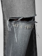 Evy Jeans - Women’s flared denim jeans with slit and embroidered “Art Is Truth” message