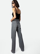 Evy Jeans - Women’s flared denim jeans with slit and embroidered “Art Is Truth” message