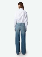 Whitney Jeans - Loose-fitting faded blue denim jeans with Looney Tunes patches.
