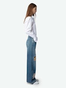Whitney Jeans - Loose-fitting faded blue denim jeans with Looney Tunes patches.