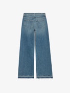 Whitney Jeans - Loose-fitting faded blue denim jeans with Looney Tunes patches.