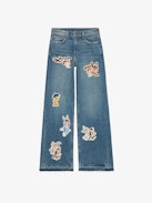 Whitney Jeans - Loose-fitting faded blue denim jeans with Looney Tunes patches.