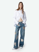 Whitney Jeans - Loose-fitting faded blue denim jeans with Looney Tunes patches.