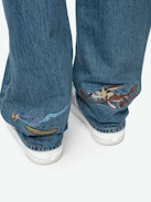 Stevie 90's Jeans - Women's straight leg light wash jeans with Roadrunner & Whiley Coyote patches.