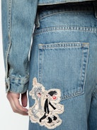 Whitney Wide Leg Patch Jeans - Women's wide leg medium wash jeans with Sylvester & Buggs Bunny patches.