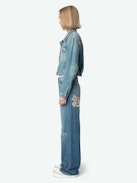Aretha Cropped Patches Jacket - Women's medium wash cropped denim jacket with Warner Bros. patch on back.