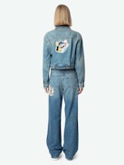 Aretha Cropped Patches Jacket - Women's medium wash cropped denim jacket with Warner Bros. patch on back.