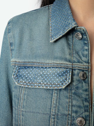 Kioky Denim Jacket - A contemporary twist on a classic wardrobe staple. This fitted denim jacket features a button-up front adorned with subtle rhinestone embellishments, adding a touch of understated glamour to its timeless design. Equipped with multiple pockets, it seamlessly blends functionality with style. Perfect for layering over any ensemble, effortlessly transitioning from casual daywear to chic evening attire.