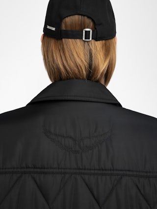 Parka Kina - Parka longue unie matelassée, multi poches et fermeture boutonnée.