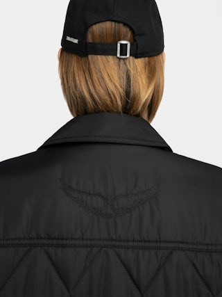 Parka Kina - Parka longue unie matelassée, multi poches et fermeture boutonnée.