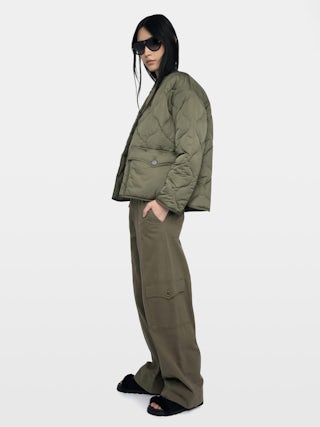 Bunji Short Quilted Parka - Short quilted parka with front patch pockets and button closure.