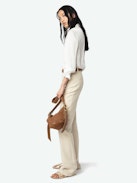 Pistol Pants - A masterful blend of classic tailoring and modern sophistication. These flared, tailored pants are crafted from premium cotton with a refined weave, offering a structured yet comfortable fit. Featuring practical pockets and a sleek silhouette, the Pistol Pants transition effortlessly from day to night.