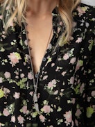Twina Soft Crinkle Roses Shirt - Embrace timeless elegance with this women’s black roses blouse, adorned with a delicate floral print. Featuring a round, buttoned neckline and half-button closure, this blouse offers a sophisticated yet romantic look. The long sleeves with tailored cuffs provide a polished finish, making it perfect for both casual outings and formal occasions.