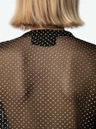 Tandy Blouse - Sheer black shirt with round neckline, button fastening, long ruffled sleeves and sequin embellishment.