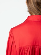 Trenta Satin Blouse - Long-sleeved satin blouse with buttoned V-neck and gathered shoulders.