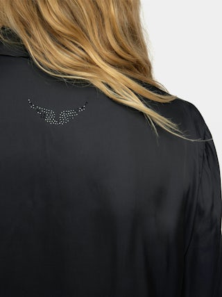 Camisa Thely Satin - Camisa de satén, manga larga, cierre con botones y strass en forma de ala en la espalda.