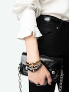 Thely Satin Shirt - Women's white satin blouse with long sleeves, gathered cuffs, and fishnet wings embroidery on the back.