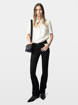 Topher Satin Top - Effortlessly polished and endlessly versatile, this ruched satin top adds a refined edge to your wardrobe. Crafted from luxurious Japanese recycled satin, it features delicate ruching along the neckline for a flattering, feminine touch. A subtle button closure and short sleeves complete the look. This ruched satin top transitions seamlessly from desk to dinner.