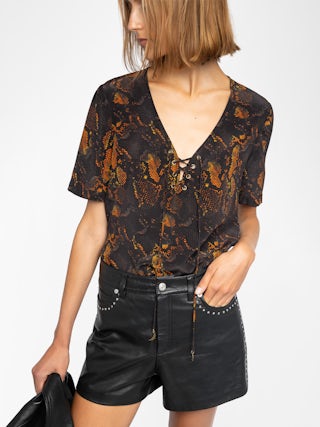 Terzo Top 100% Silk - Printed silk top, laced V-neckline with metallic wings and short sleeves.