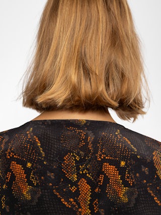 Terzo Top 100% Silk - Printed silk top, laced V-neckline with metallic wings and short sleeves.