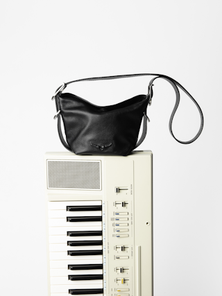 Baby Jane Bag - Leather bag with adjustable shoulder strap and debossed wing signature.