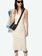 Astra Dress - A sleek tank dress that embodies the brand's signature edgy elegance. This white dress features distinctive wing-shaped embellishments on the front, adding a unique flair to its minimalist design. The Astra Dress is a versatile addition to any wardrobe, seamlessly transitioning from day to night with effortless style.